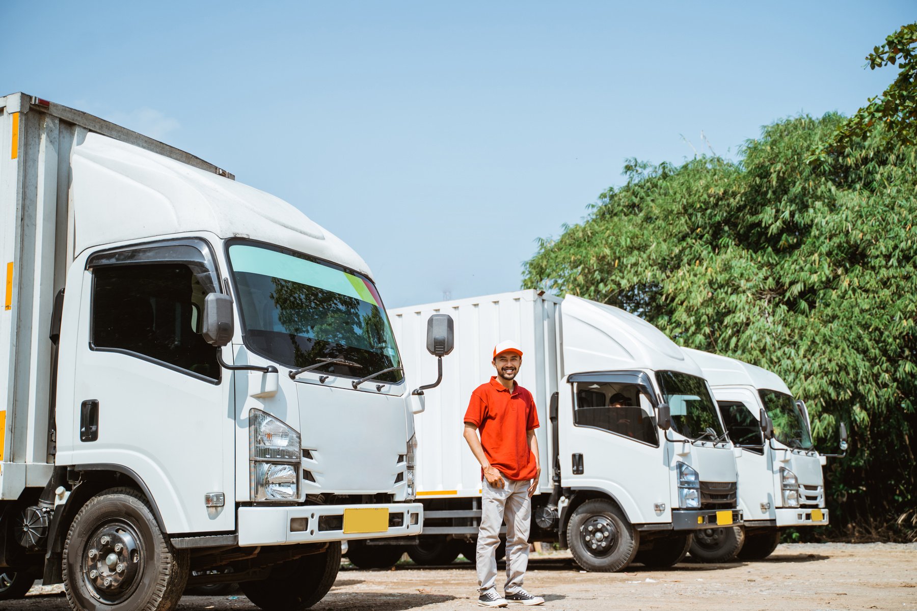 Delivery Man Driver in Red Uniform Standing near Delivery Truck